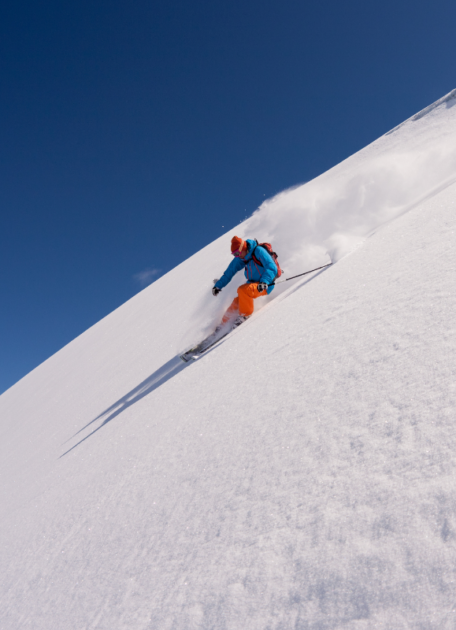 A skier on a steep slope as a metaphor for cost reduction